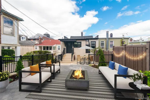 an outdoor sitting area with furniture and wooden floor