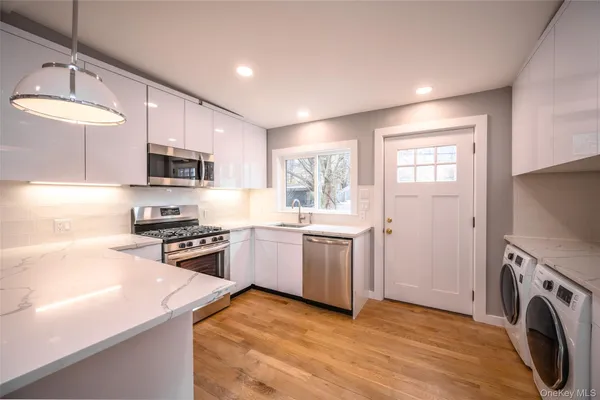 a kitchen with a sink a stove and cabinets