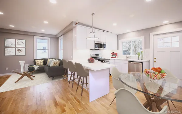 a living room with furniture and kitchen view
