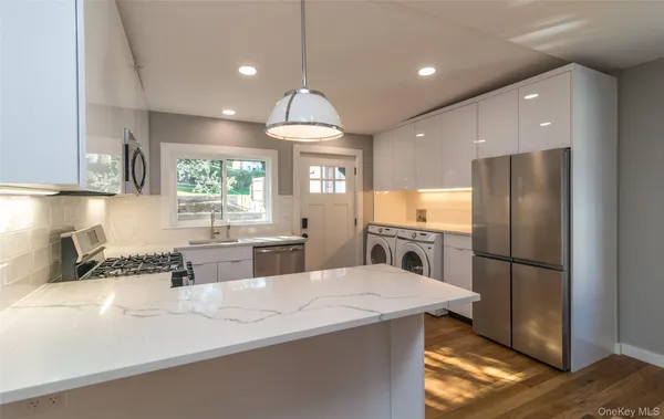 a kitchen with stainless steel appliances a sink stove and refrigerator