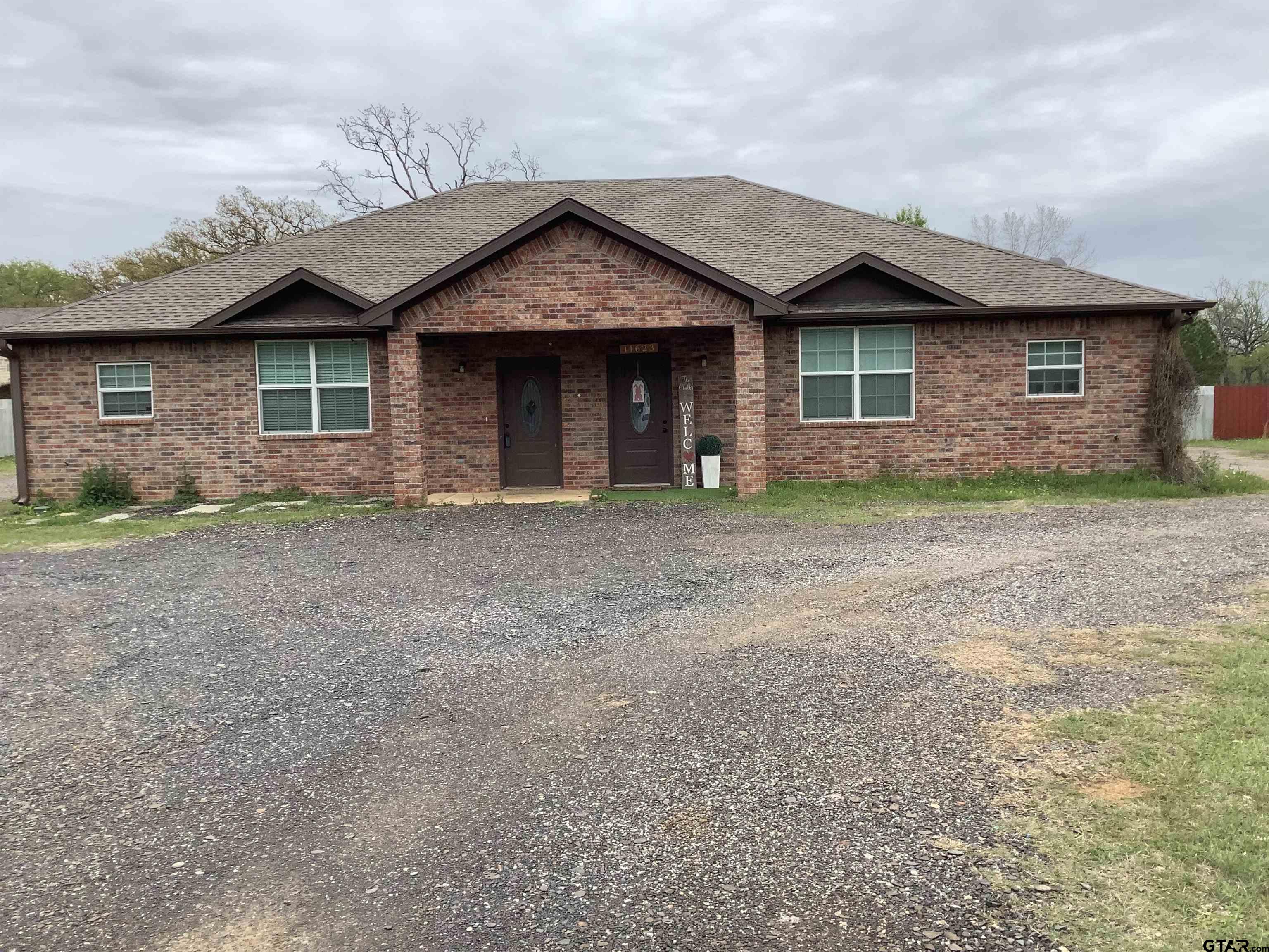 11621 FM 848 Tyler, TX 75707 - Photo 1 of 15 a front view of a house with garden