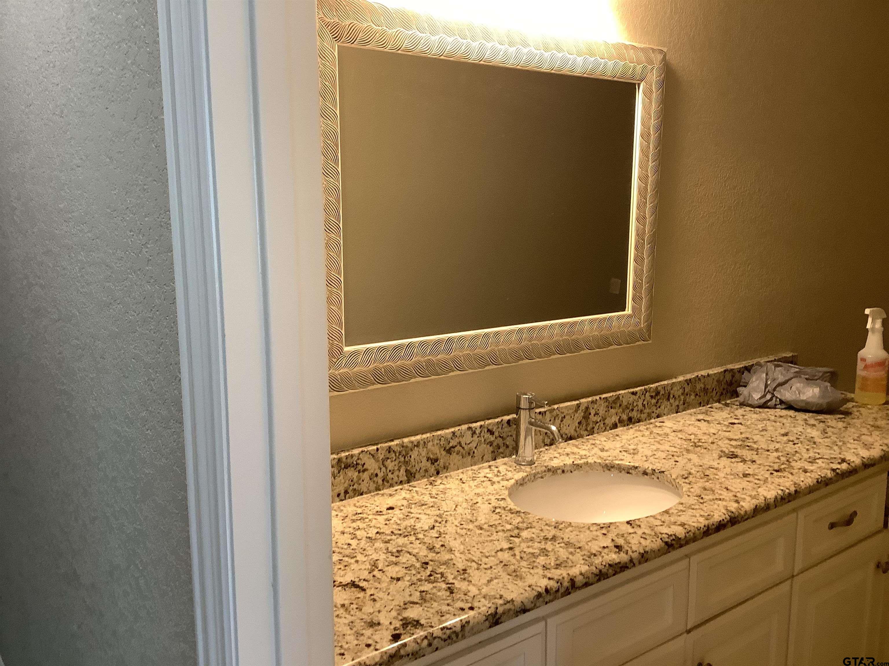 11621 FM 848 Tyler, TX 75707 - Photo 12 of 15 a bathroom with a granite countertop sink and a mirror