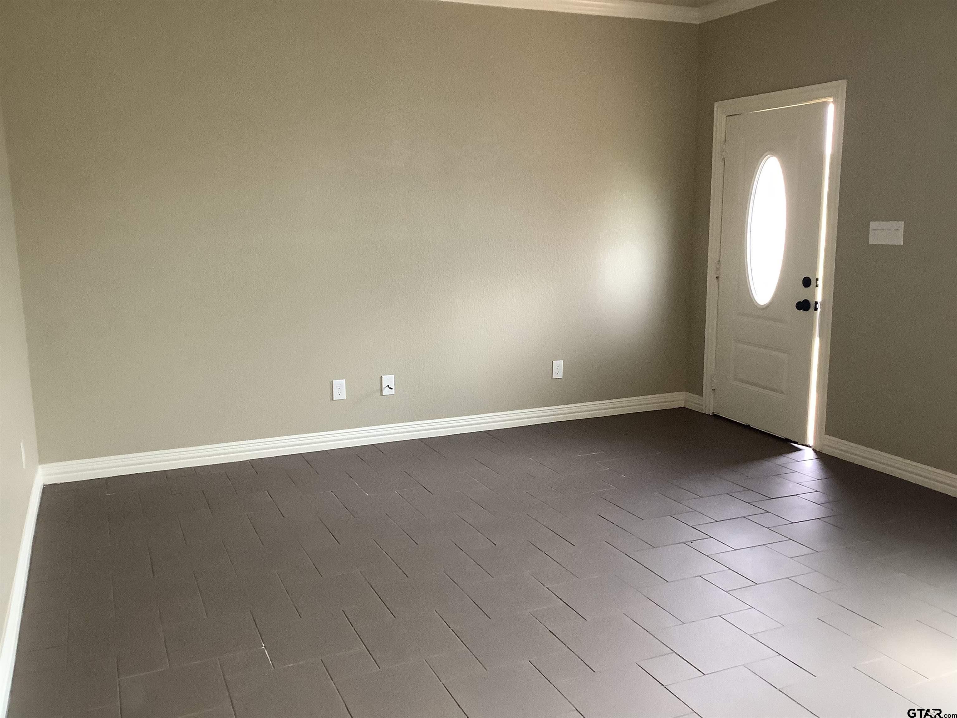 11621 FM 848 Tyler, TX 75707 - Photo 13 of 15 an empty room with wooden floor and windows