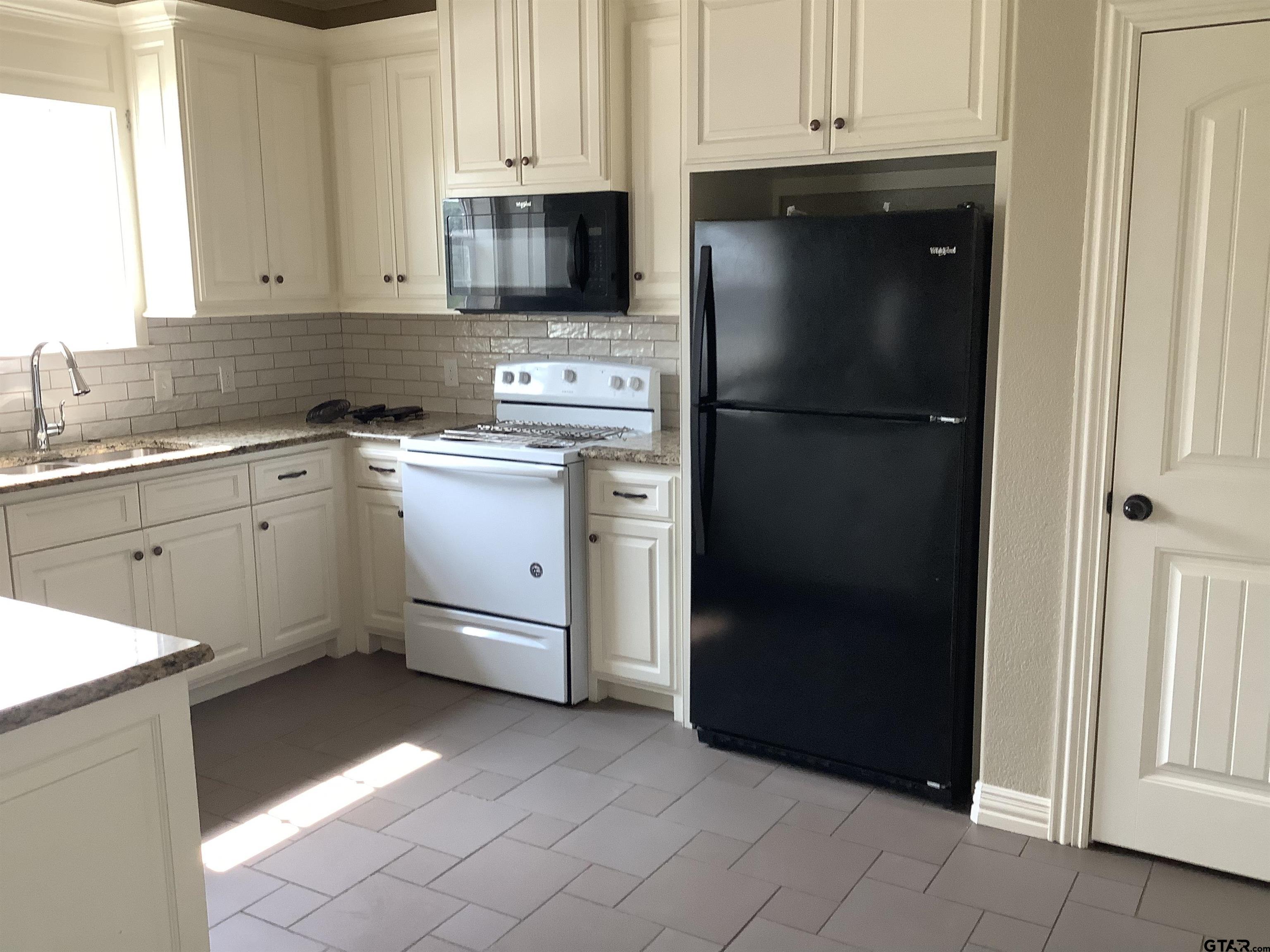 11621 FM 848 Tyler, TX 75707 - Photo 14 of 15 a kitchen with stainless steel appliances granite countertop a refrigerator and a stove