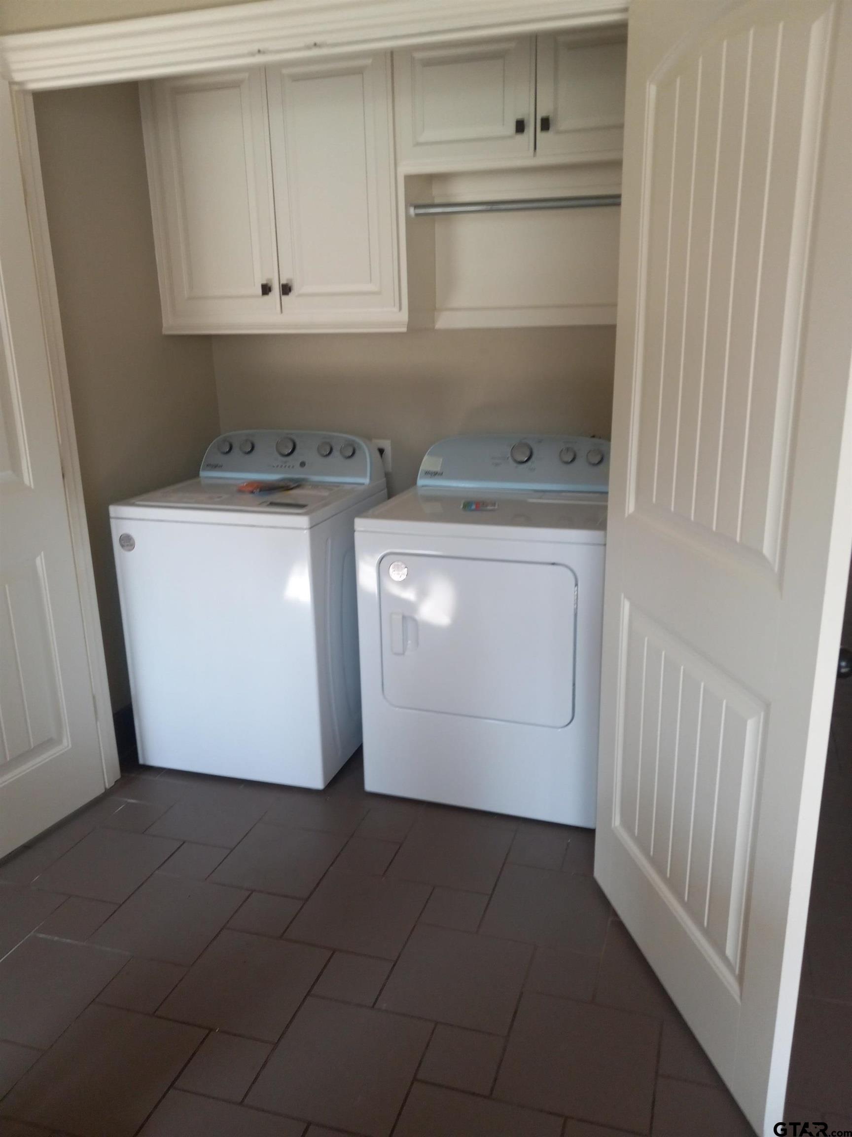 11621 FM 848 Tyler, TX 75707 - Photo 15 of 15 a utility room with cabinets washer and dryer