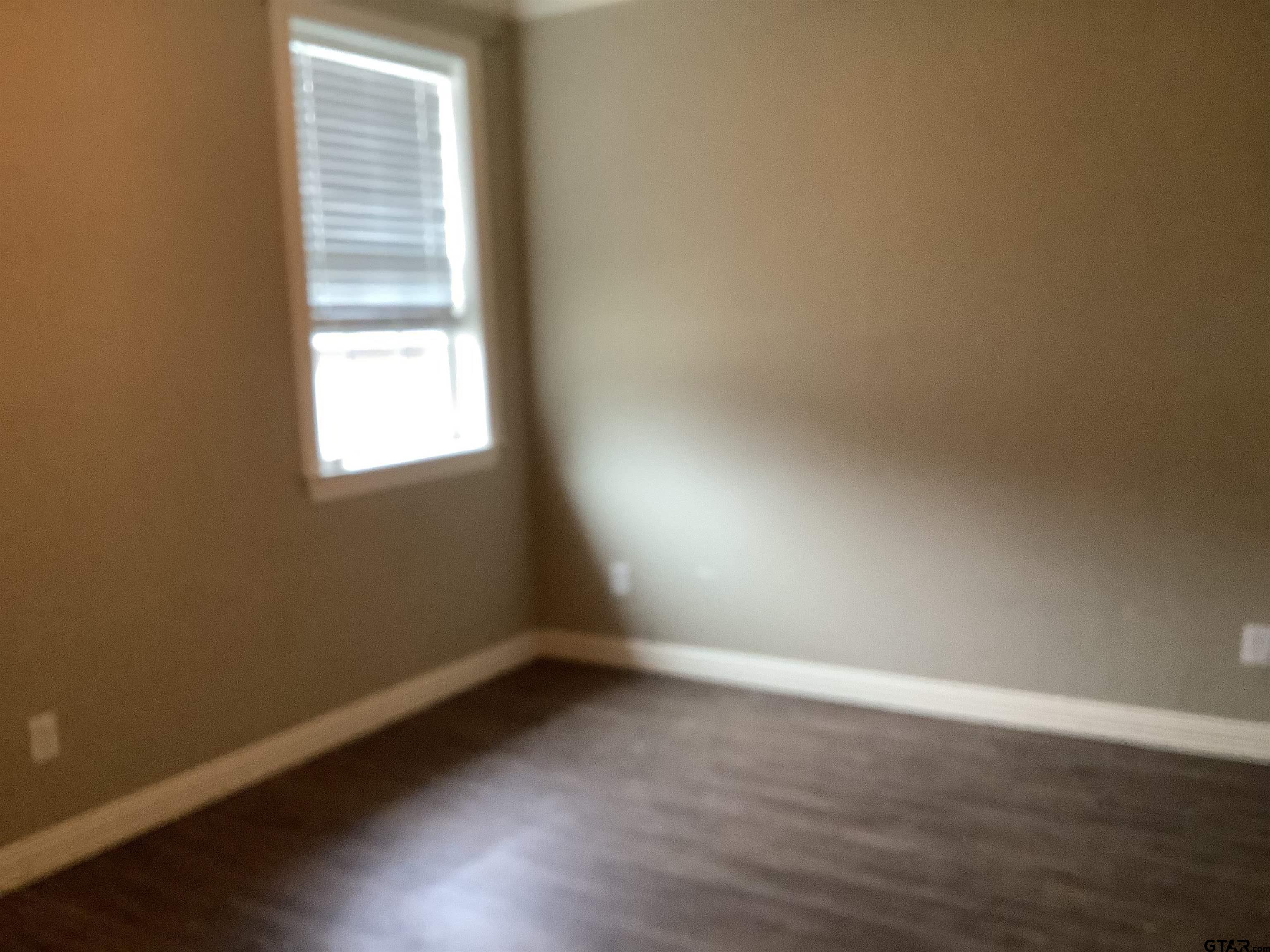 11621 FM 848 Tyler, TX 75707 - Photo 7 of 15 an empty room with wooden floor and windows