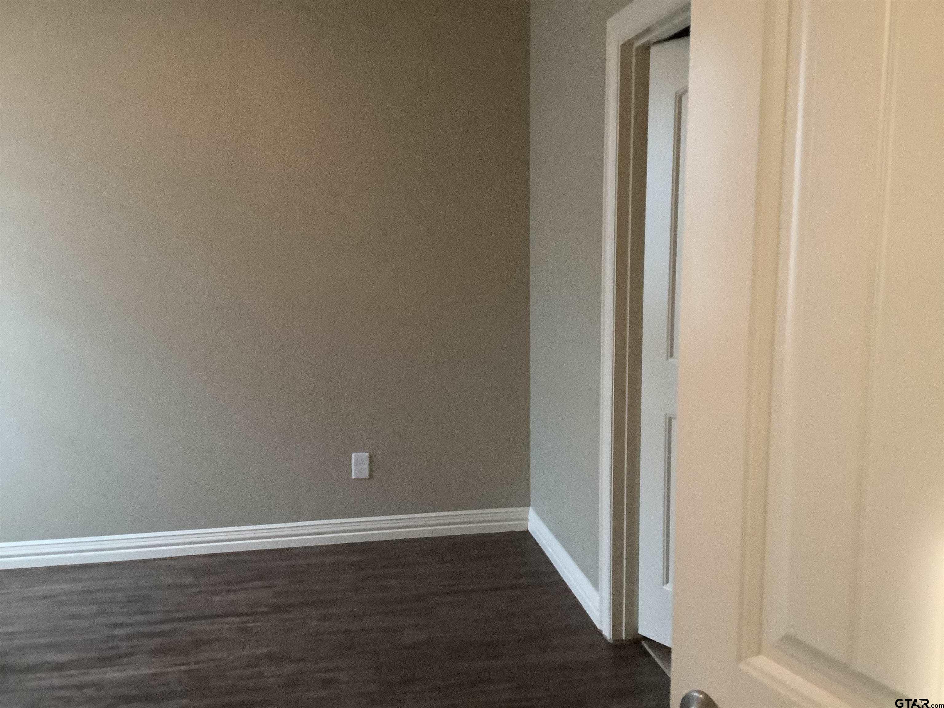 11621 FM 848 Tyler, TX 75707 - Photo 8 of 15 a view of an empty room with wooden floor