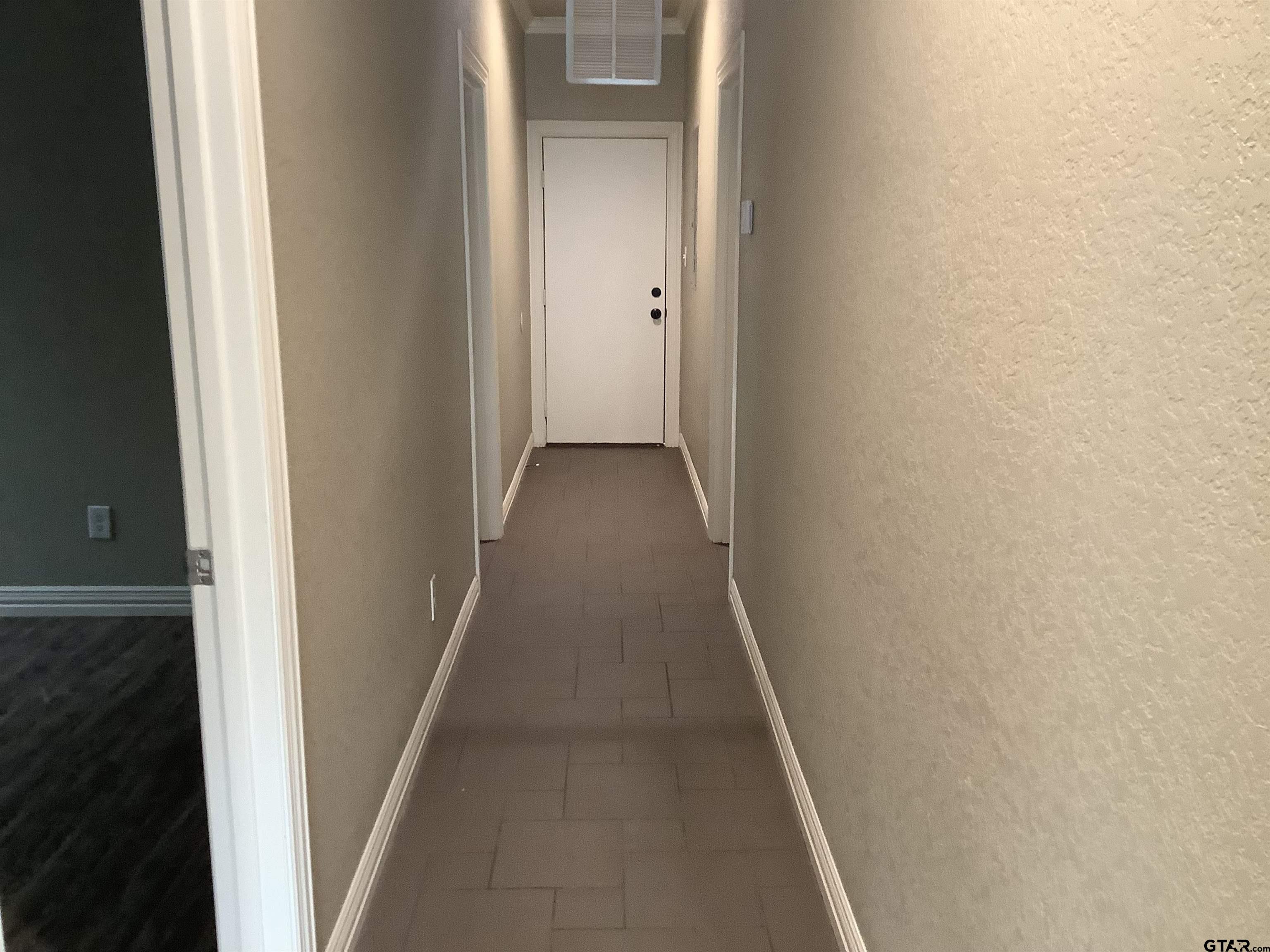 11621 FM 848 Tyler, TX 75707 - Photo 10 of 15 a view of a hallway with a wooden floor