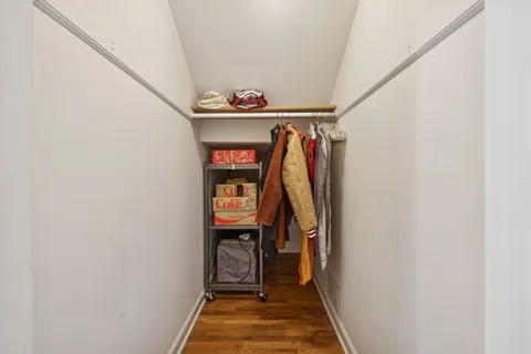 a view of walk in closet with clothes and shoes