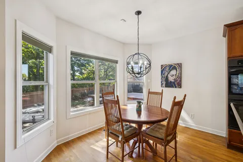 a view of a dining room with furniture window and wooden floor
