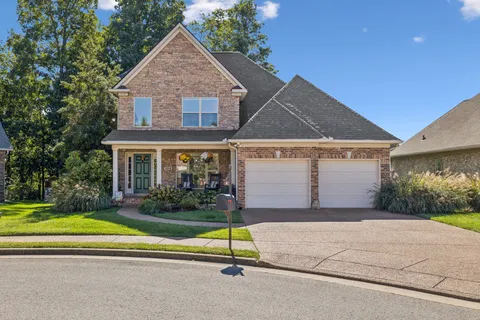 a view of house with outdoor space and garden