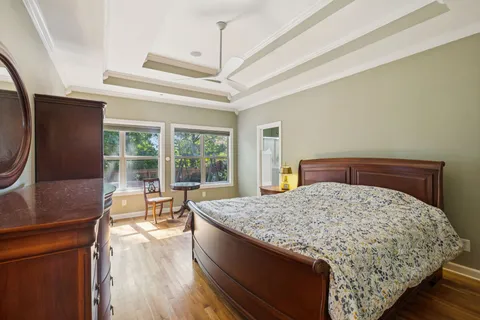 a bed sitting in a bedroom next to a window