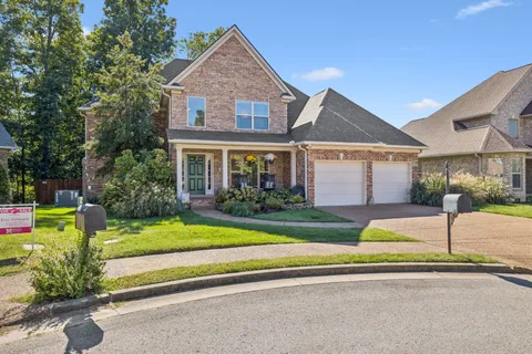 a front view of a house with a yard and porch