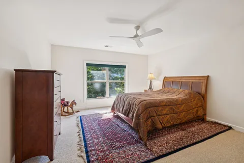 a bedroom with a large bed and a window