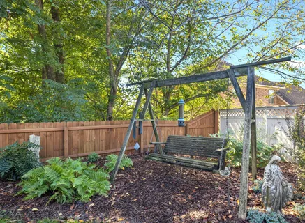 a backyard of a house with plants and tree