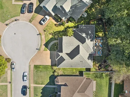 an aerial view of a house with swimming pool garden and patio