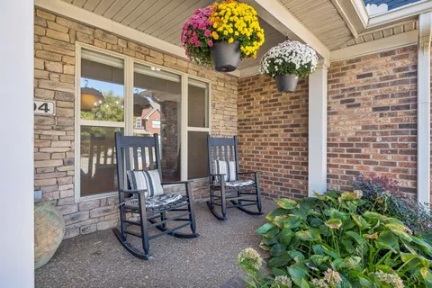 a front view of a house with outdoor seating