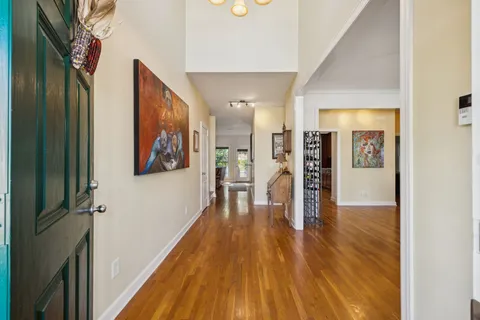a view of a hallway with wooden floor