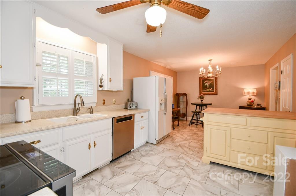 9101 Bartlett Road Mint Hill, NC 28227 - Photo 11 of 20 a large white kitchen with a window and refrigerator