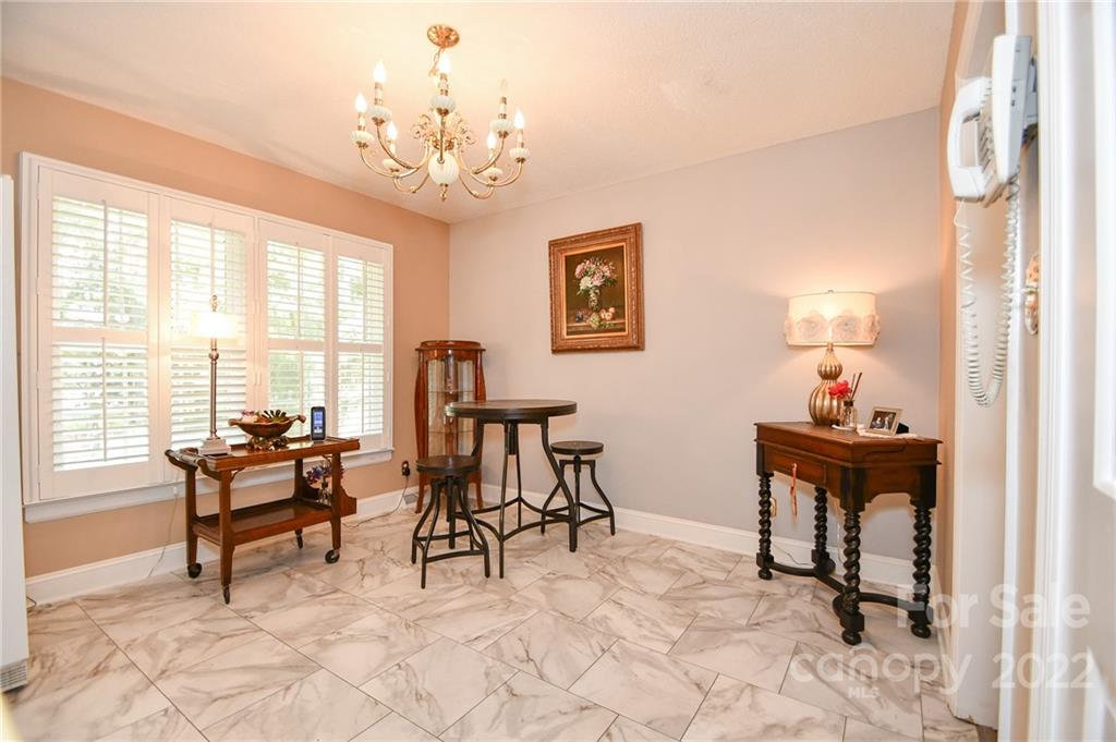 9101 Bartlett Road Mint Hill, NC 28227 - Photo 12 of 20 a living room with furniture and a chandelier