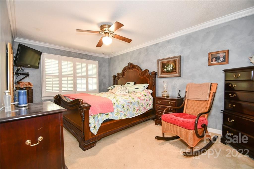 9101 Bartlett Road Mint Hill, NC 28227 - Photo 15 of 20 a bedroom with a bed and dresser with window