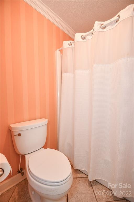 9101 Bartlett Road Mint Hill, NC 28227 - Photo 17 of 20 a white toilet sitting next to a shower curtain