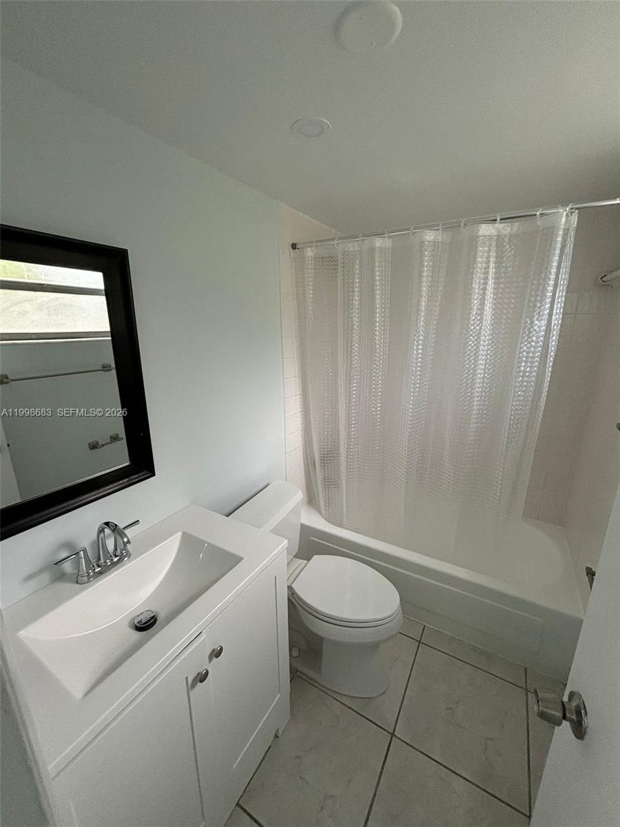 8101 Southwest 73rd Avenue, Unit 1 Miami, FL 33143 - Photo 11 of 52 a bathroom with a sink a toilet and tub