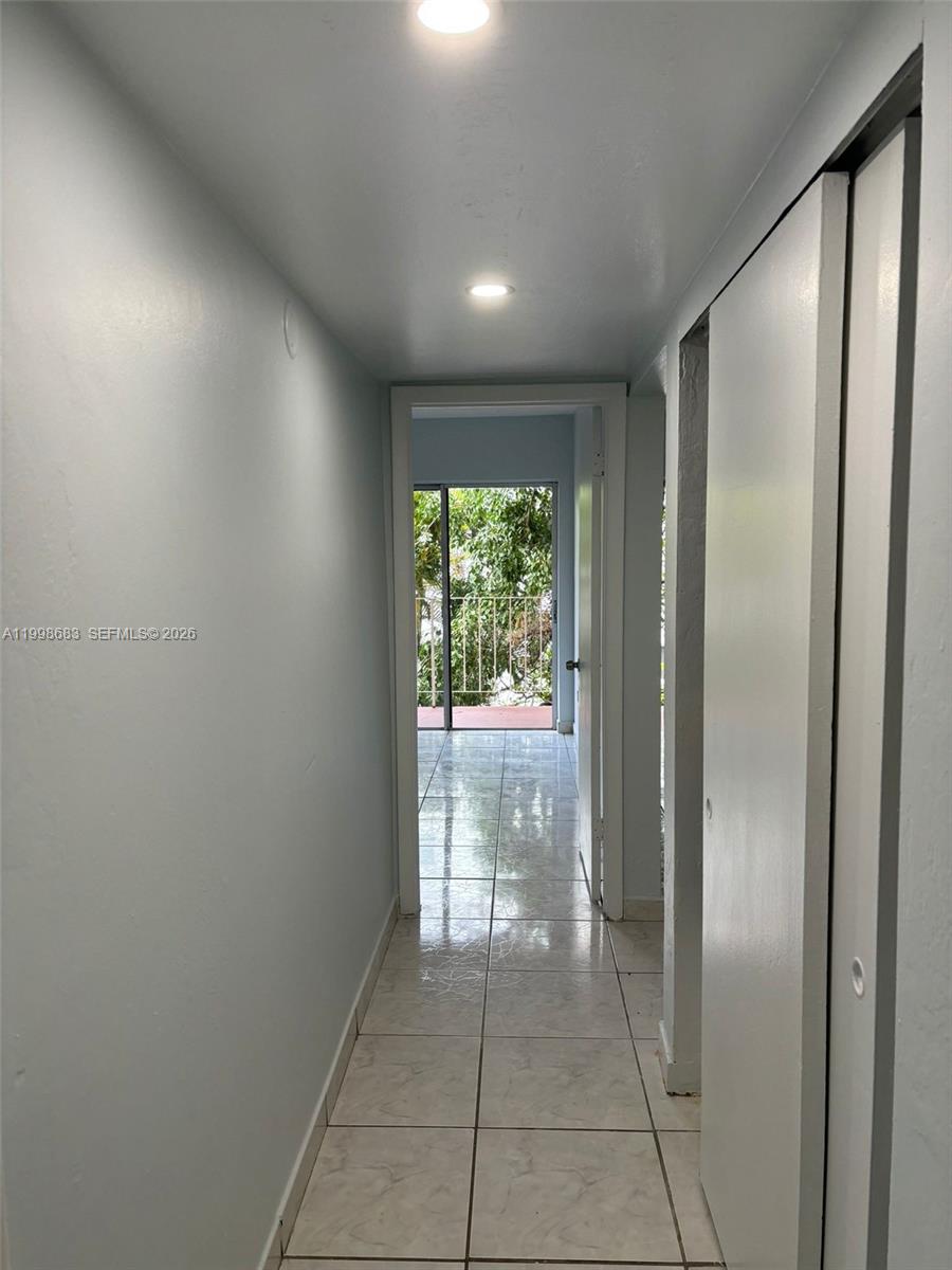 8101 Southwest 73rd Avenue, Unit 1 Miami, FL 33143 - Photo 12 of 52 a view of hallway with a large window and front door