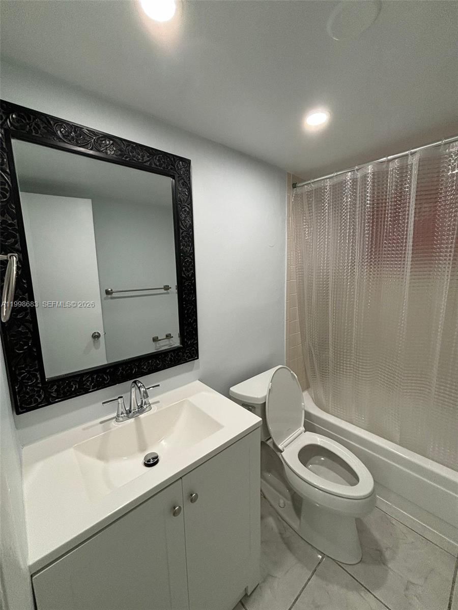 8101 Southwest 73rd Avenue, Unit 1 Miami, FL 33143 - Photo 15 of 52 a bathroom with a sink a toilet and shower