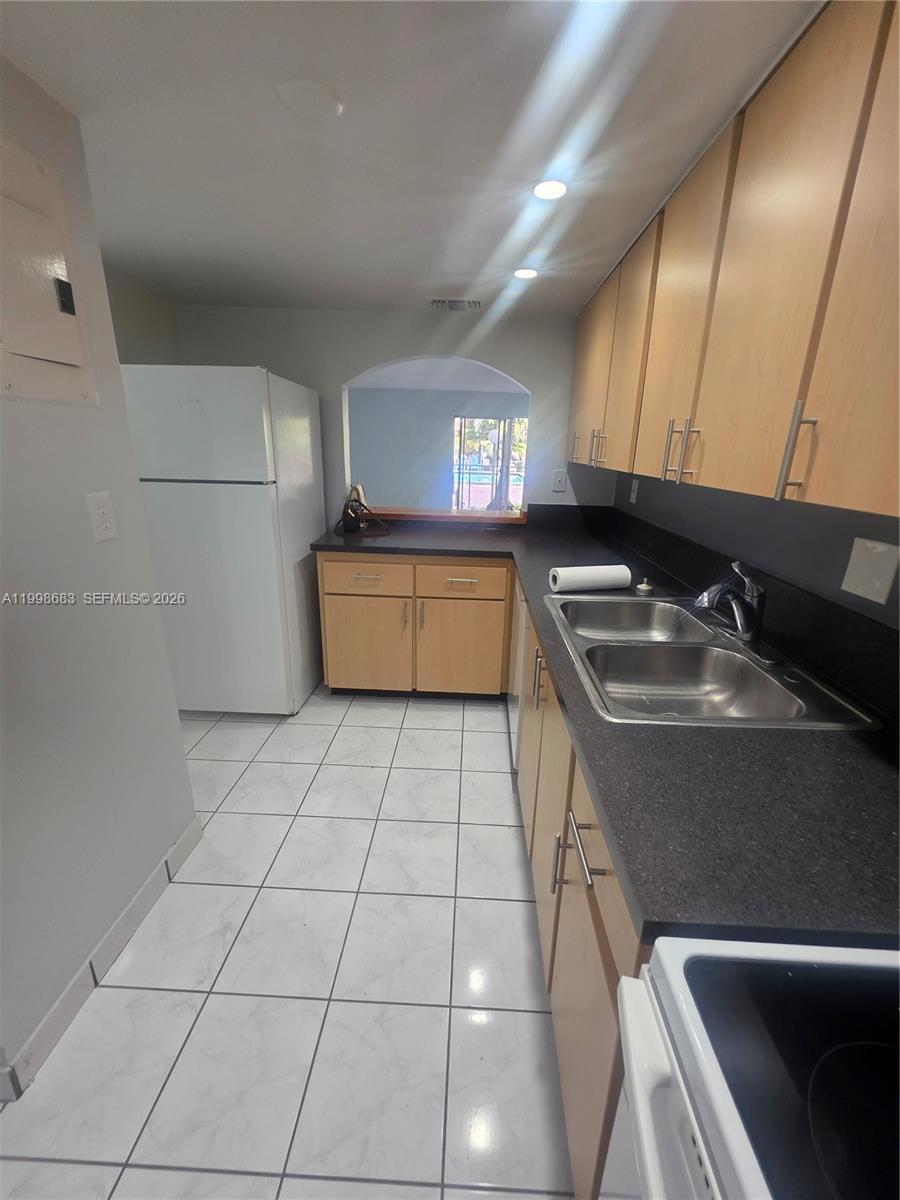 8101 Southwest 73rd Avenue, Unit 1 Miami, FL 33143 - Photo 30 of 52 a kitchen with stainless steel appliances a sink stove and cabinets