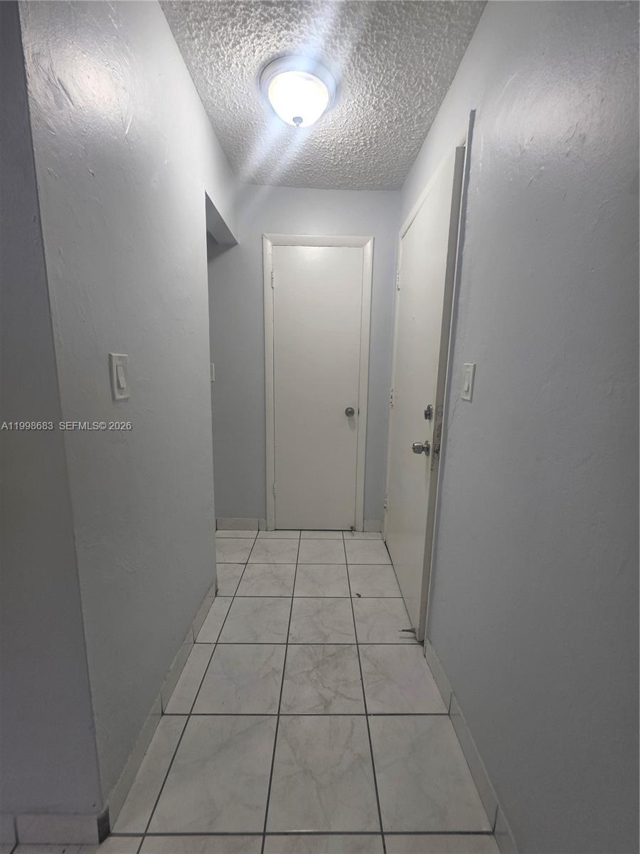 8101 Southwest 73rd Avenue, Unit 1 Miami, FL 33143 - Photo 32 of 52 an empty room with white walls and tiles