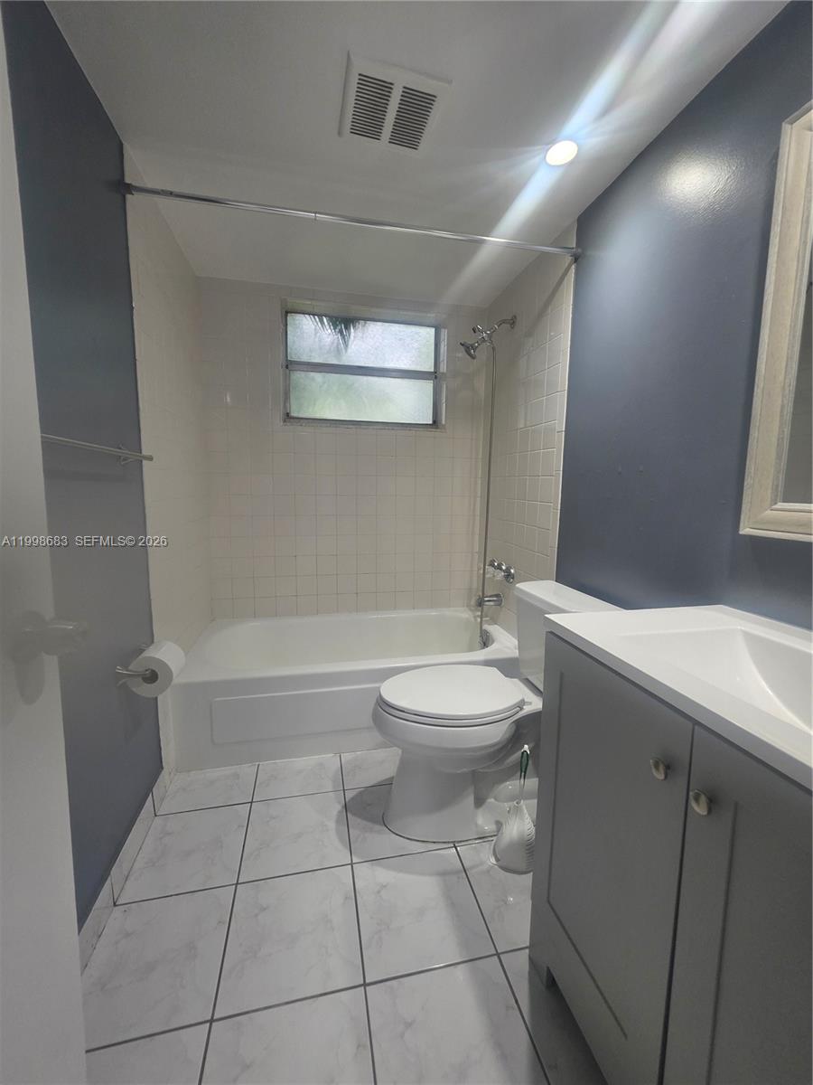 8101 Southwest 73rd Avenue, Unit 1 Miami, FL 33143 - Photo 33 of 52 a bathroom with a toilet a sink and bathtub