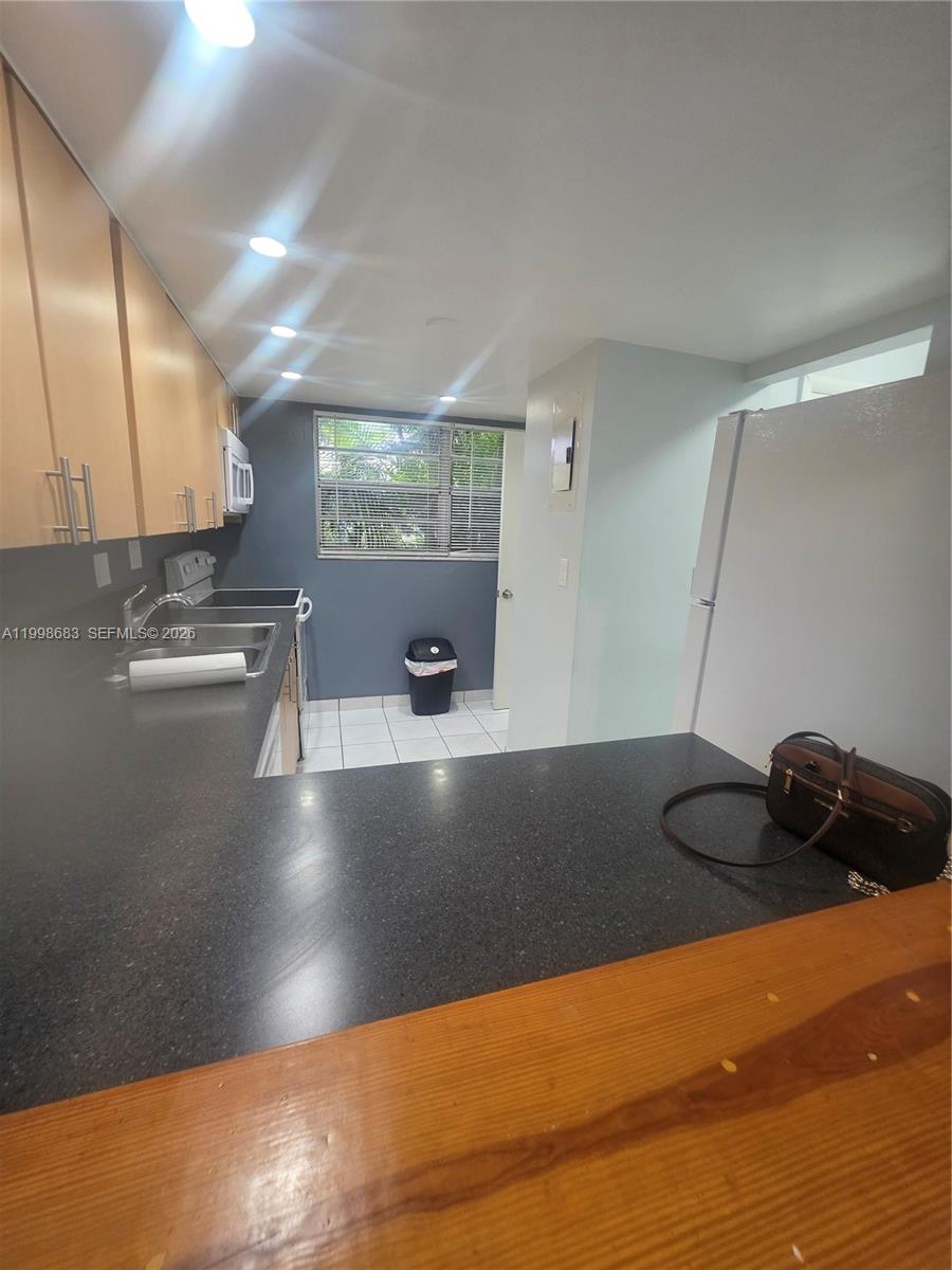 8101 Southwest 73rd Avenue, Unit 1 Miami, FL 33143 - Photo 37 of 52 a view of a kitchen with a sink and cabinets