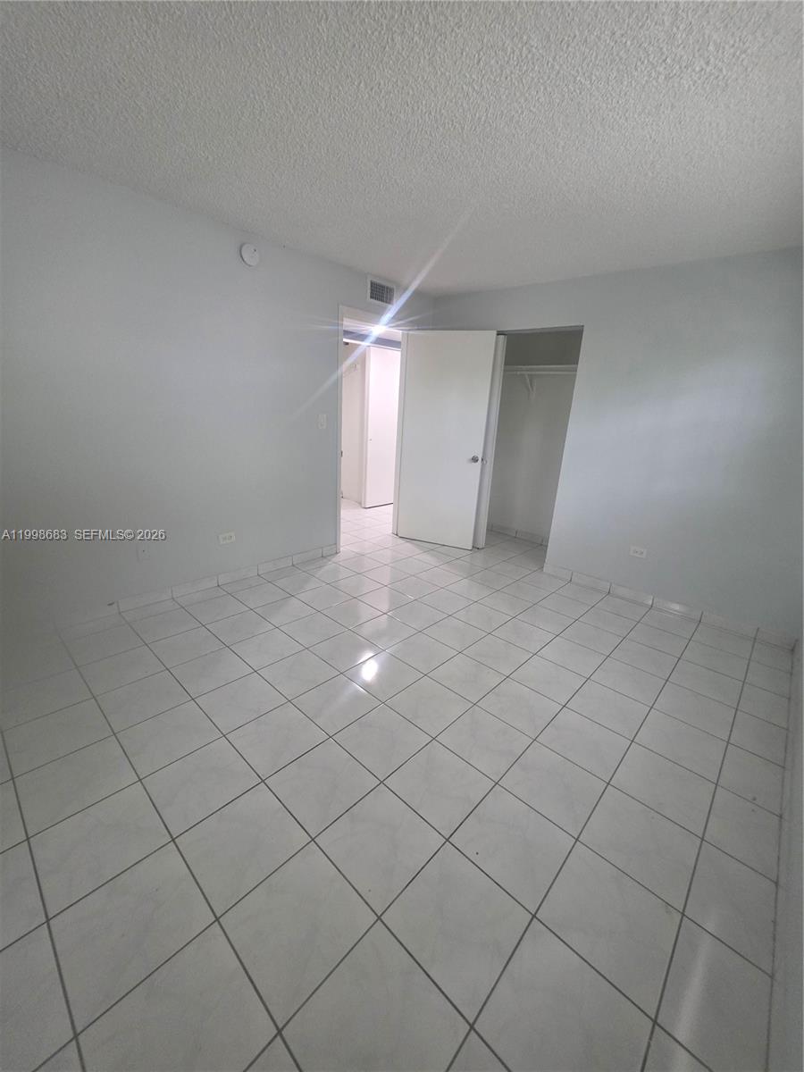 8101 Southwest 73rd Avenue, Unit 1 Miami, FL 33143 - Photo 39 of 52 an empty room with a ceiling fan and window