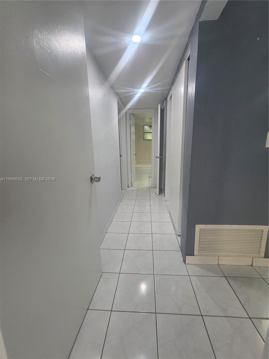 8101 Southwest 73rd Avenue, Unit 1 Miami, FL 33143 - Photo 45 of 52 a view of hallway with a mirror and a shower