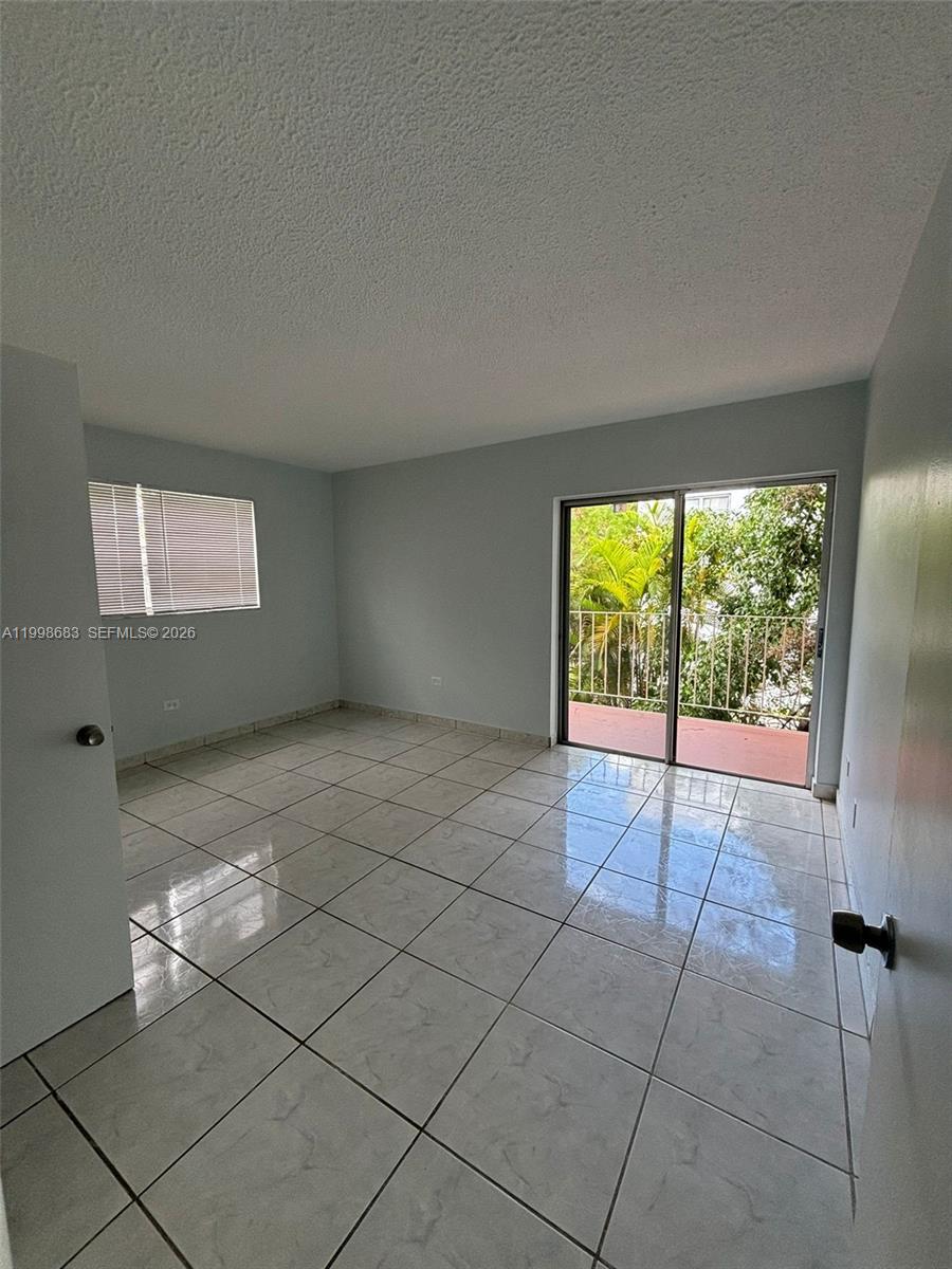 8101 Southwest 73rd Avenue, Unit 1 Miami, FL 33143 - Photo 10 of 52 a view of an empty room with a window