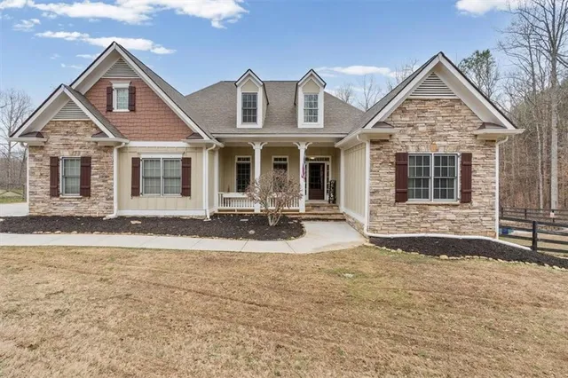 a front view of a house with yard porch and outdoor seating