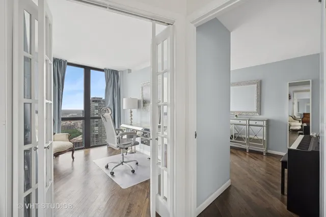 a hallway with wooden floor and furniture