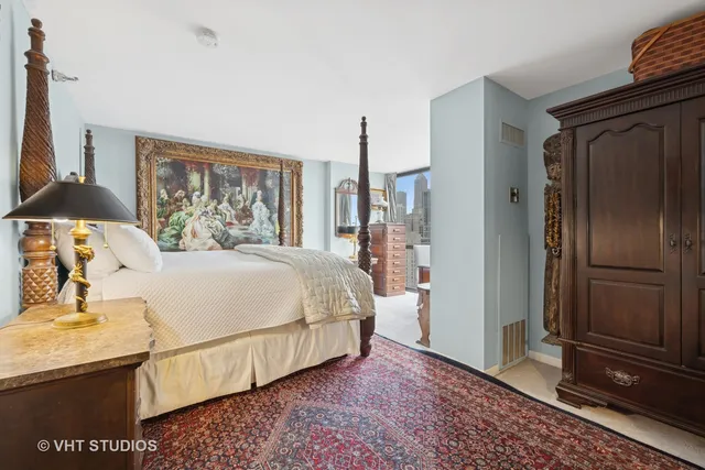 a bedroom with a bed and a dresser