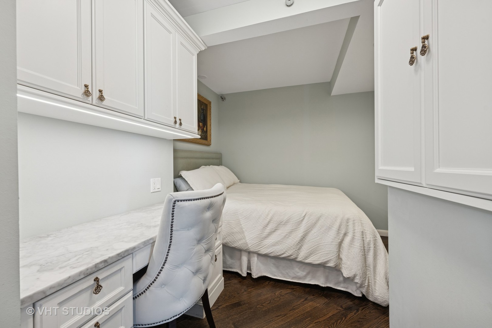 1122 North Clark Street, Unit 330110 Chicago, IL 60610 - Photo 19 of 22 a bedroom with a bed and cabinets