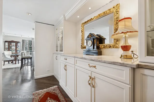 a kitchen with sink and mirror
