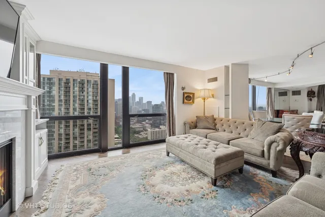 a living room with furniture a fireplace and a table