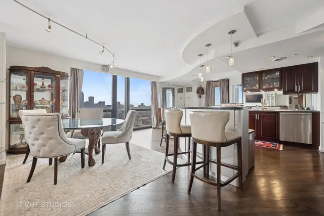 a living room with stainless steel appliances kitchen island granite countertop furniture and a kitchen view