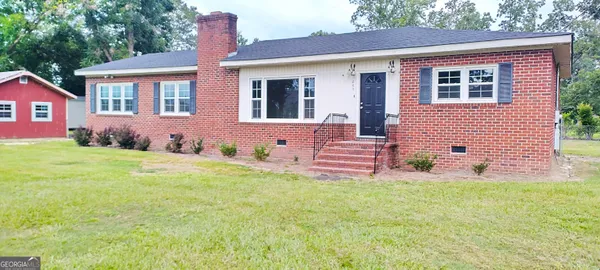 a front view of a house with a yard and porch