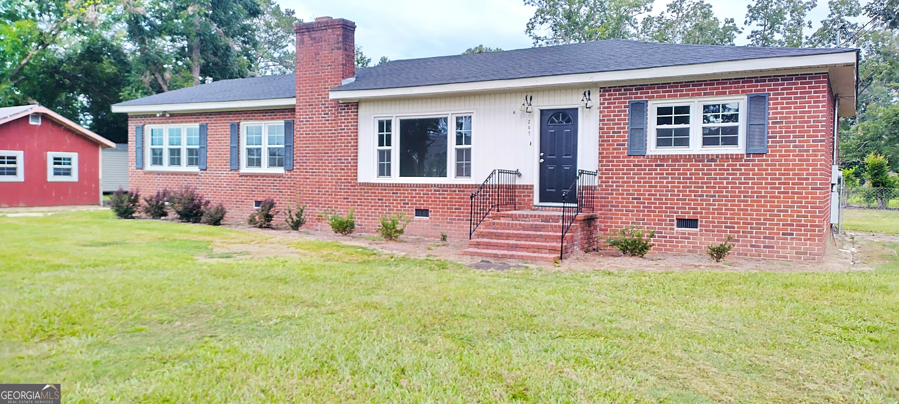 207 Dixie Street Brooklet, GA 30415 - Photo 1 of 1 a front view of a house with a yard and porch