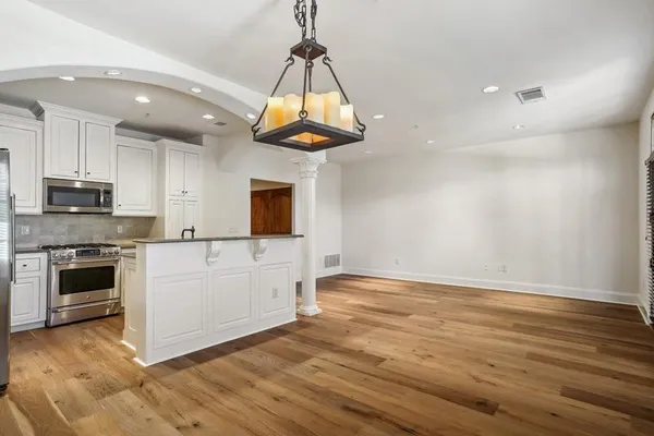 a kitchen with stainless steel appliances granite countertop a stove a refrigerator and a microwave