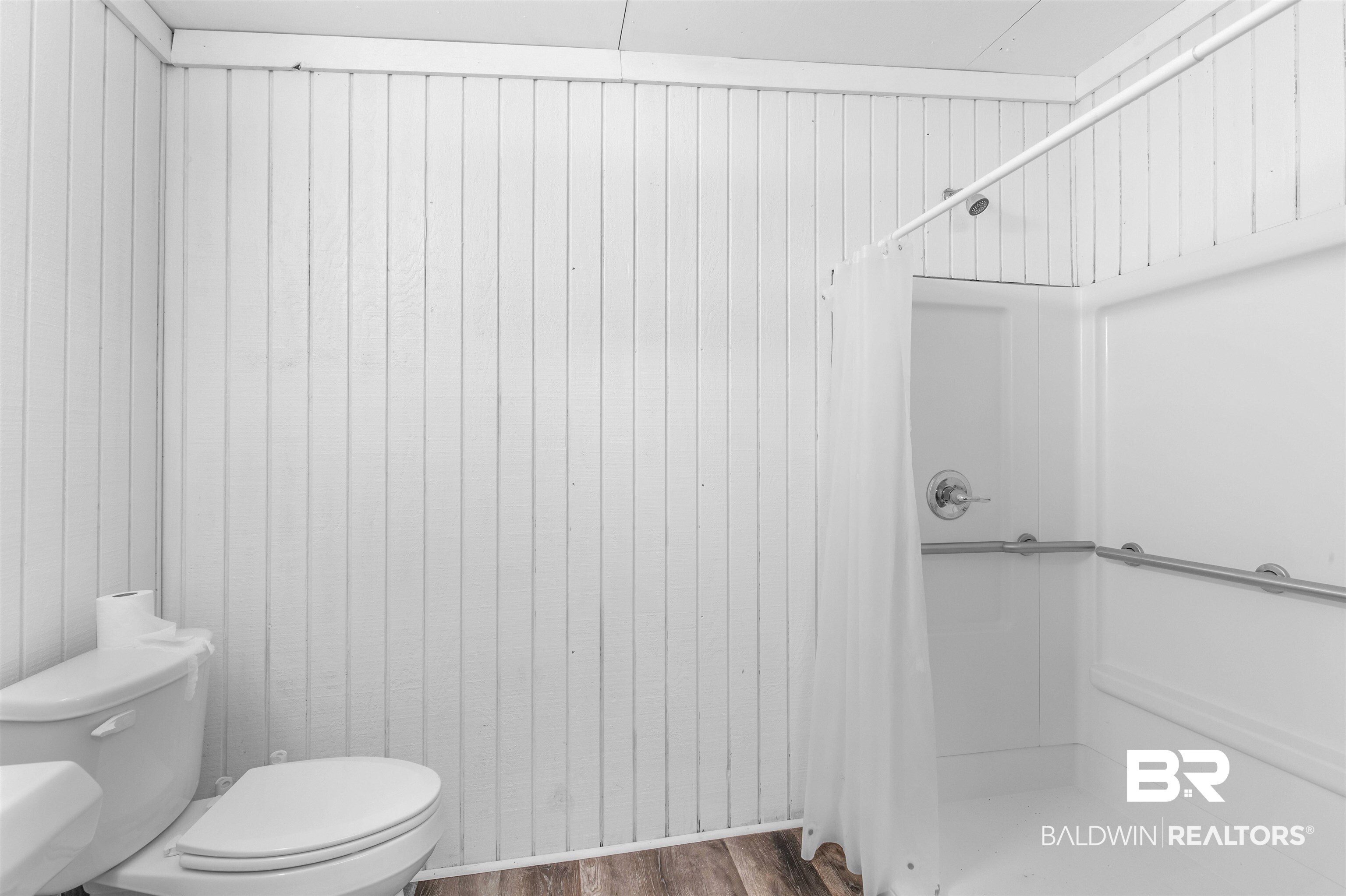 28290 Canal Road Orange Beach, AL 36561 - Photo 21 of 32 Full bath featuring toilet, wood finished floors, and a shower with shower curtain