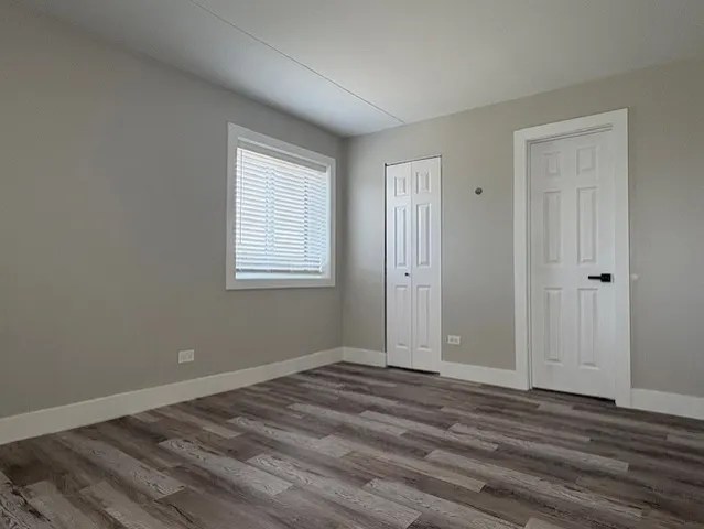 a view of a room with wooden floor and window