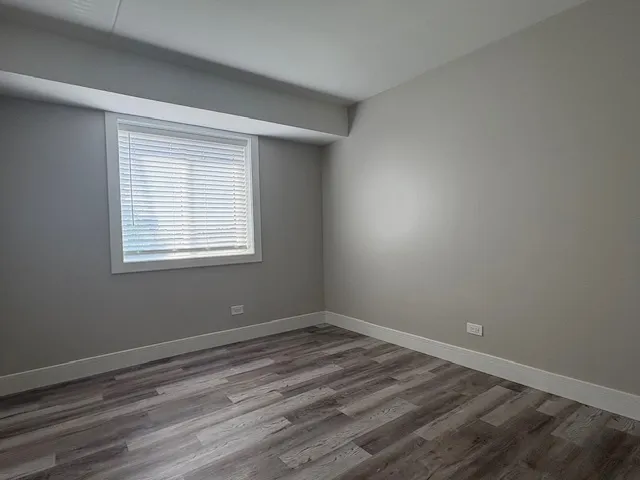 a view of a room with wooden floor and windows