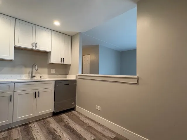 a kitchen with cabinets appliances and a window